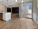 Open kitchen with stainless steel appliances, island counter and view to back porch and living room at 8212 Merryvale Ln, Charlotte, NC 28214