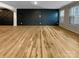 Spacious living room featuring luxury vinyl plank flooring and dark accent wall at 8212 Merryvale Ln, Charlotte, NC 28214