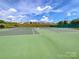 Multiple tennis courts with green surfaces, perfect for community play and recreation at 8212 Merryvale Ln, Charlotte, NC 28214