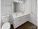 Clean bathroom featuring dual sinks, a toilet, and a shower at 8715 Green Ivy Ln, Charlotte, NC 28217