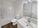Bathroom featuring a bathtub with shower, toilet, mirror and vanity at 8715 Green Ivy Ln, Charlotte, NC 28217