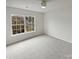 Bright bedroom with large window and ceiling fan; neutral color scheme at 8715 Green Ivy Ln, Charlotte, NC 28217