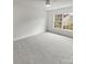 Bright and airy bedroom with a large window and neutral carpeting at 8715 Green Ivy Ln, Charlotte, NC 28217
