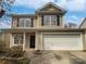 Charming two-story home with a two car garage and beautifully landscaped front yard at 8715 Green Ivy Ln, Charlotte, NC 28217