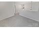 Spacious loft area with neutral carpet and a modern lighting fixture, perfect for relaxing at 8715 Green Ivy Ln, Charlotte, NC 28217