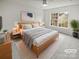 Tranquil main bedroom with a large window, ceiling fan, and plush rug at 8715 Green Ivy Ln, Charlotte, NC 28217