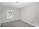 This bedroom has a window for natural lighting and neutral colored walls and carpet at 914 Saluda St, Rock Hill, SC 29730