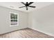 This bedroom features a ceiling fan, a window overlooking the yard, and neutral walls and flooring at 914 Saluda St, Rock Hill, SC 29730