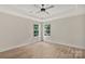 This bedroom features neutral walls and flooring and two windows overlooking the trees at 914 Saluda St, Rock Hill, SC 29730
