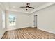 Bedroom featuring tray ceiling with fan, bright light from the windows, and laminate flooring at 914 Saluda St, Rock Hill, SC 29730
