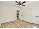 Bedroom with light walls, wood-look floors, ceiling fan, and view to the kitchen at 914 Saluda St, Rock Hill, SC 29730