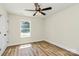 Bedroom with light walls, wood-look floors, ceiling fan, window and white trim at 914 Saluda St, Rock Hill, SC 29730
