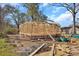 View of the new home construction with lumber and brick base on a clear day at 914 Saluda St, Rock Hill, SC 29730