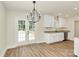 Bright dining area next to white kitchen, featuring a chandelier and a view to backyard at 914 Saluda St, Rock Hill, SC 29730