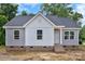 Charming exterior view of a single-story home with gray and white siding and brick foundation at 914 Saluda St, Rock Hill, SC 29730