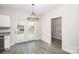 Bright kitchen/dining nook with modern chandelier and door to rear deck, adjacent to laundry room at 914 Saluda St, Rock Hill, SC 29730