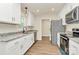 Well-equipped kitchen features white cabinets, granite counters, stainless appliances and new wood flooring at 914 Saluda St, Rock Hill, SC 29730