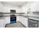 Modern kitchen featuring stainless steel appliances, white cabinetry, and granite countertops at 914 Saluda St, Rock Hill, SC 29730