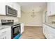 Beautiful, modern kitchen with granite countertops, new appliances, and an open view to the dining area at 914 Saluda St, Rock Hill, SC 29730