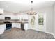 Well-lit kitchen features stainless steel appliances, white cabinets, and granite countertops at 914 Saluda St, Rock Hill, SC 29730