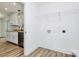 Bright laundry room area equipped with washer and dryer hookups and laminate wood flooring at 914 Saluda St, Rock Hill, SC 29730