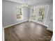 Bright dining area with modern light fixture and French doors leading to the backyard at 9144 Cameron Wood Dr, Charlotte, NC 28210