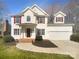 Charming two-story home with red shutters, a well-manicured lawn, and a two car garage at 9144 Cameron Wood Dr, Charlotte, NC 28210