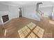 Bright living room features hardwood floors, a fireplace, and stairs leading to the second floor at 9144 Cameron Wood Dr, Charlotte, NC 28210