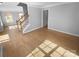 Open-concept living area with hardwood floors and staircase, bathed in natural light at 9144 Cameron Wood Dr, Charlotte, NC 28210