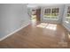 Bright living room featuring hardwood floors and large windows, providing ample natural light at 9144 Cameron Wood Dr, Charlotte, NC 28210