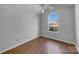 This bedroom features laminate floors and a unique arched window at 1025 Ridgefield Cir, Indian Trail, NC 28079