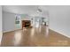 Open-concept living room with a fireplace, abundant natural light, and seamless flow to the kitchen at 1025 Ridgefield Cir, Indian Trail, NC 28079