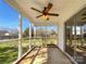 Relaxing screened porch with a ceiling fan, offering a serene outdoor space and backyard views at 1025 Ridgefield Cir, Indian Trail, NC 28079
