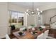 Bright dining room showcasing modern light fixture, hardwood floors, and large window at 1027 Oleander Ln, Waxhaw, NC 28173