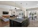 Open-concept kitchen featuring a large island with a sink and adjacent living and dining areas at 1027 Oleander Ln, Waxhaw, NC 28173