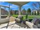 Relaxing screened patio with cozy seating, a patterned rug, and views of the lush backyard at 1027 Oleander Ln, Waxhaw, NC 28173