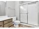 Bathroom with a glass-enclosed shower and vanity with drawers and countertop at 10663 Hill Point Ct, Charlotte, NC 28262