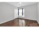 Bedroom featuring wood flooring, one window and a closet at 10663 Hill Point Ct, Charlotte, NC 28262