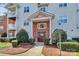Charming condominium building with well-manicured landscaping, a welcoming entrance, and reserved parking at 10663 Hill Point Ct, Charlotte, NC 28262
