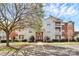 Inviting multi-story condo building featuring balconies, brick accents, well-maintained landscaping, and accessible parking at 10663 Hill Point Ct, Charlotte, NC 28262