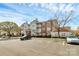 Multi-story apartment building with brick accents, balconies, and ample parking on a sunny day at 10663 Hill Point Ct, Charlotte, NC 28262