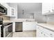 Updated kitchen with stainless steel appliances and white cabinets with open layout at 10663 Hill Point Ct, Charlotte, NC 28262