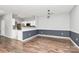 Bright open-concept living area with wood floors, neutral colors, and modern lighting at 10663 Hill Point Ct, Charlotte, NC 28262