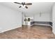 Open-concept living area with hardwood floors, a ceiling fan, and a view into the kitchen at 10663 Hill Point Ct, Charlotte, NC 28262