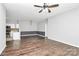 Spacious living room with hardwood floors, ceiling fan, and open access to kitchen at 10663 Hill Point Ct, Charlotte, NC 28262