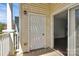 View of the patio entrance with a white door and sliding glass doors leading to the indoors at 10663 Hill Point Ct, Charlotte, NC 28262