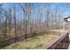 Backyard view from the deck with a wooden fence and the surrounding woods at 107 Grand Canyon Rd, Stanley, NC 28164