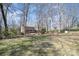 Expansive backyard perfect for outdoor activities and relaxation under a canopy of trees at 107 Grand Canyon Rd, Stanley, NC 28164