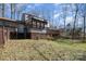Exterior view of the home with a deck, sunroom, and wooded backyard at 107 Grand Canyon Rd, Stanley, NC 28164