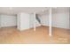Spacious finished basement with white walls, laminate flooring, and a staircase at 107 Grand Canyon Rd, Stanley, NC 28164